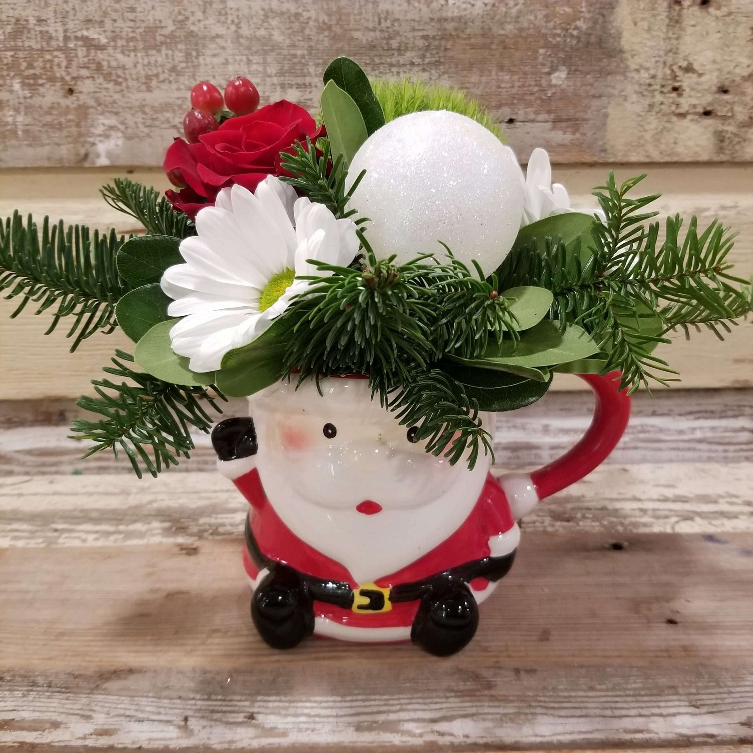 Flower arrangement in a santa mug great gift for the holidays and christmas